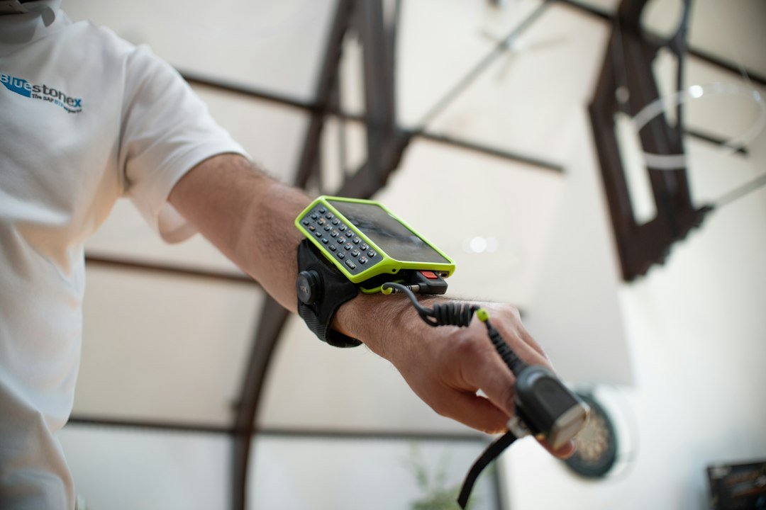 Man wearing a device on his arm with a cable