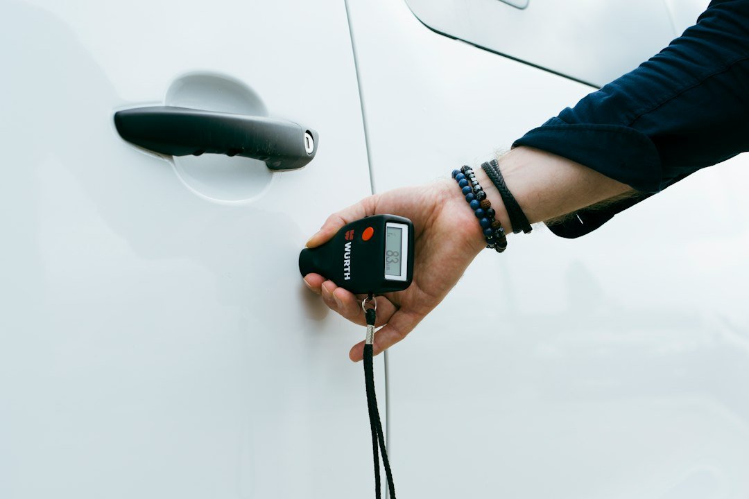 A person is holding a car door handle