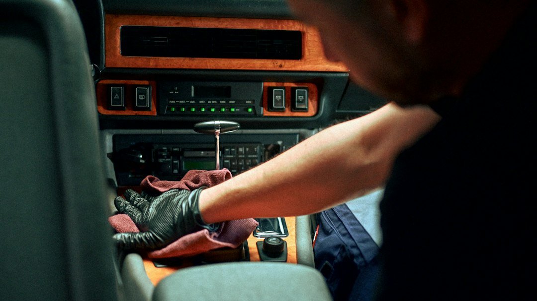 Mechanic working on car interior dashboard