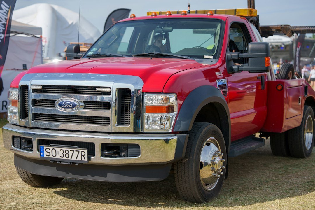 A red ford tow truck parked outdoors